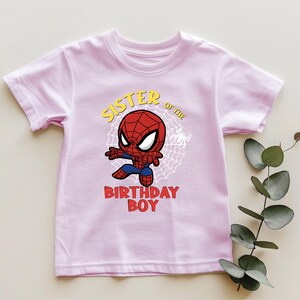 a pink shirt with a spiderman on it