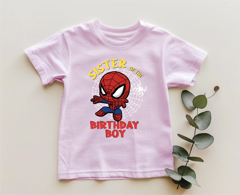 a pink shirt with a spiderman on it