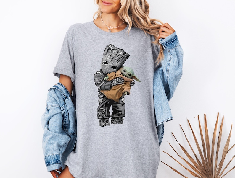 a woman wearing a t - shirt with a baby groote on it