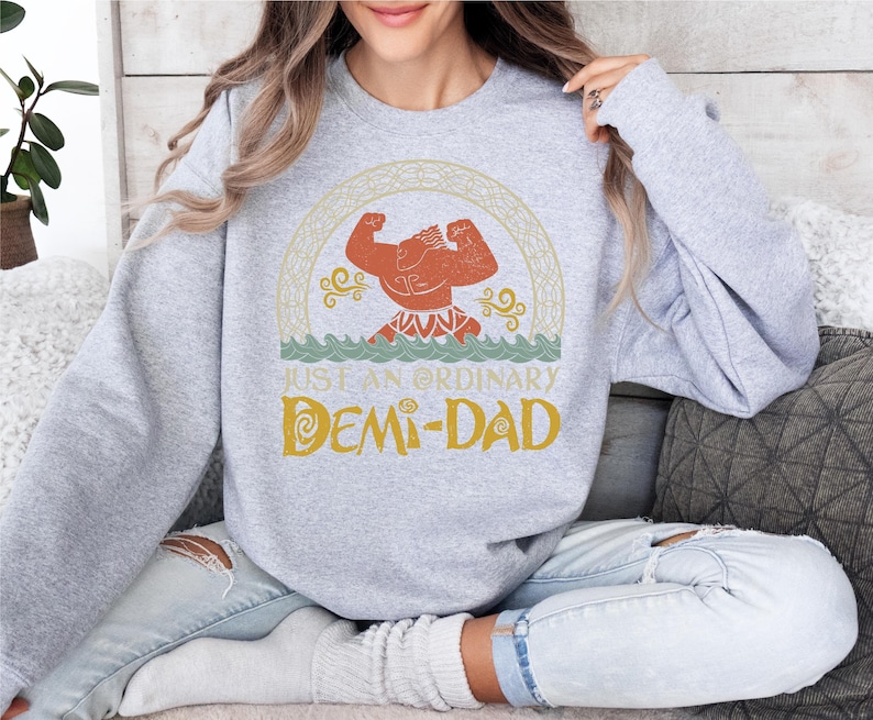 a woman sitting on a couch wearing a sweatshirt