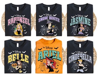 May include: Six black t-shirts with different Disney princess characters in a Halloween theme. The shirts feature the princesses dressed in witch costumes with bats and spiderwebs in the background. The text on the shirts reads "Disney" and the name of the princess. The princesses featured are Rapunzel, Snow White, Jasmine, Belle, Ariel, and Cinderella.