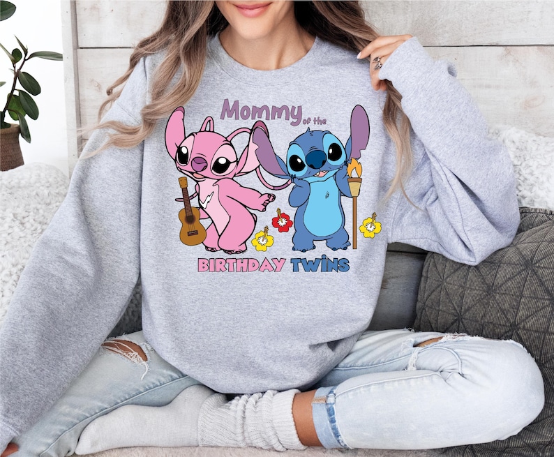 a woman sitting on a couch wearing a sweatshirt