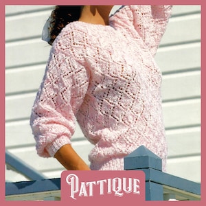 May include: A pink knitted sweater with a delicate openwork pattern. The sweater has a round neckline and long sleeves.