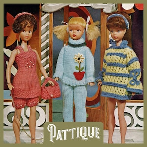 May include: Three dolls wearing knitted outfits. The doll on the left is wearing a pink dress and matching shorts with a beaded detail. The doll in the middle is wearing a blue sweater and matching pants with a flower design. The doll on the right is wearing a yellow and blue striped sweater. The dolls are standing in front of a colorful background with the word "PATTIQUE" printed at the bottom.