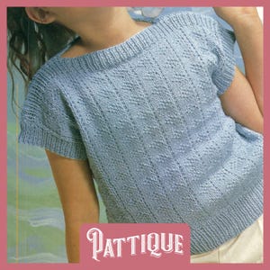 May include: A light blue knitted top with a diamond pattern and short sleeves. The top has a round neckline and is made with a fine yarn. The text "PATTIQUE" is visible at the bottom of the image.