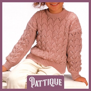 May include: A pink knitted jumper with a lacy pattern. The jumper has a round neckline and long sleeves.