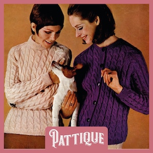 May include: Two women wearing cable knit sweaters. One sweater is pink and the other is purple. The woman in the pink sweater is holding a small white dog.