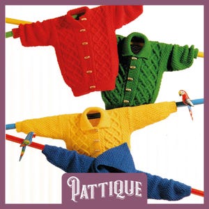 May include: Four knitted cardigans in red, green, yellow, and blue hanging on a clothesline with wooden buttons. The cardigans have a cable knit pattern.