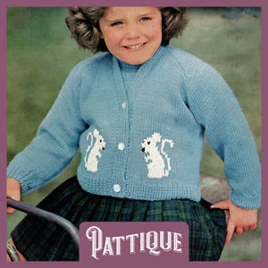 May include: A light blue knitted cardigan with white embroidered squirrels on the front. The cardigan has a button closure and is being worn by a young girl.