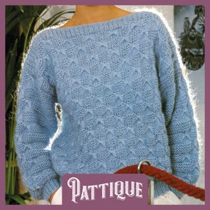 May include: A light blue knitted jumper with a textured pattern. The jumper has a boat neck and long sleeves.