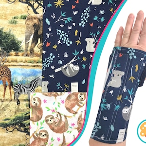 May include: A navy blue wrist brace with a pattern of koalas and sloths hanging from branches. The brace is shown on a person's hand. Other fabric swatches show safari animals and sloths.