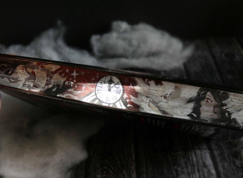 May include: A close-up of a book cover with a red, white and blue design. The cover features a clock face, stars and a figure with wings. The text "Time" is visible on the cover.