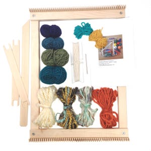 May include: A wooden tapestry weaving loom kit with various colored yarn bundles, including blue, green, yellow, and orange. The kit includes weaving tools and instructions. The loom is rectangular and has a natural wood finish.