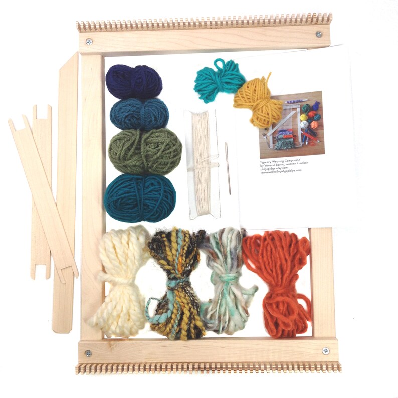 May include: A wooden tapestry weaving loom kit with various colored yarn bundles, including blue, green, yellow, and orange. The kit includes weaving tools and instructions. The loom is rectangular and has a natural wood finish.