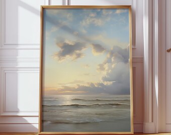 May include: A framed art print featuring a serene ocean scene. The artwork depicts a calm sea under a cloudy sky, with soft colors of blue, gold, and gray. The wooden frame adds a touch of warmth to the coastal landscape.