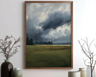 May include: A framed landscape painting depicts a dramatic sky filled with dark, swirling clouds above a green field and a distant treeline. The artwork is encased in a wooden frame, adding a touch of rustic elegance to the scene.