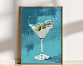 May include: A framed print featuring a martini glass with olives and a colorful lollipop. The cocktail is set against a textured teal background. The artwork is displayed in a room with a wooden floor.