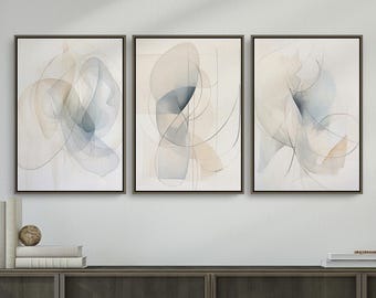 May include: Three framed abstract art prints. Each print features soft, flowing shapes in shades of blue, beige, and gray against a white background. The artwork has a minimalist style with delicate lines and watercolor-like effects. The frames are dark brown.