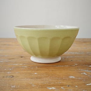 Antique faceted bowl in anise green earthenware