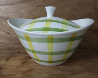 May include: A white ceramic serving dish with a lid. The dish has a green and yellow checkered pattern.