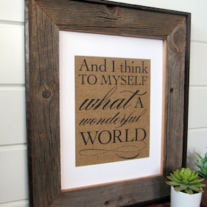May include: A rustic wood frame with a burlap background and the text "And I think to myself what a wonderful WORLD" printed in black.
