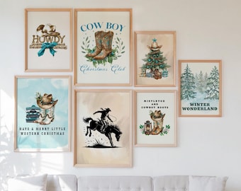May include: A gallery wall of seven framed prints featuring Western-themed Christmas illustrations, including cowboy boots, a horse, and a Christmas tree, displayed above a light gray sofa in a room with a potted plant.
