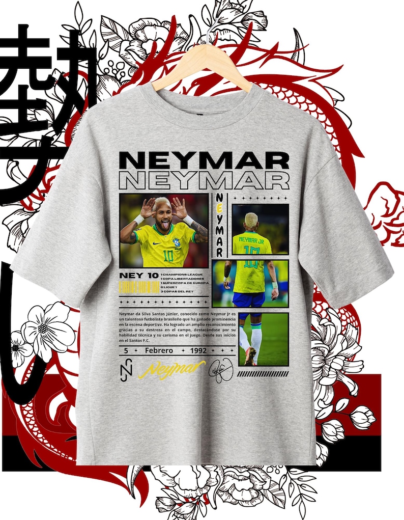 Op de afbeelding: Een grijs T-shirt met een grafisch ontwerp met een foto van voetballer Neymar Jr. Het ontwerp bevat de tekst "Neymar Neymar" in zwart en wit, en "Ney 10" in zwart. De tekst "5 Febrero 1992" is ook in het ontwerp opgenomen.