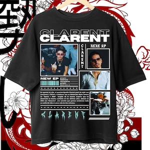 May include: Black t-shirt with the name "CLARENT" in white block letters. The shirt features images of a man wearing sunglasses and gold jewellery. Text on the shirt includes "NEW EP" and "NENE EP". Floral and dragon graphics surround the shirt.