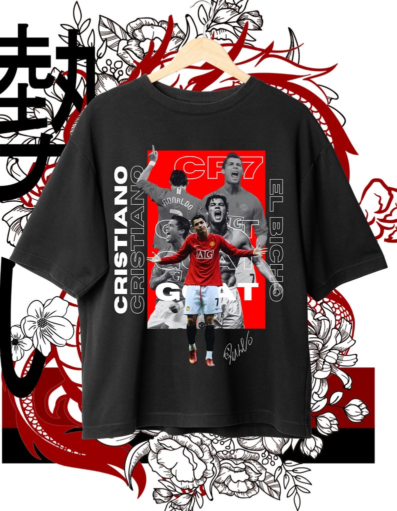 May include: Black t-shirt with a red and white graphic of Cristiano Ronaldo, a soccer player, with the text "CR7 EL BICHO" and "GOAT".