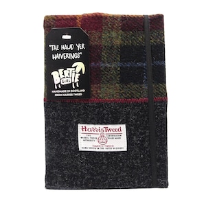 May include: A black and gray tweed notebook with a red, green, and blue plaid cover. The notebook has a black elastic closure and a label that reads "Harris Tweed" and "Hand Woven in the Outer Hebrides". The notebook also has a smaller label that reads "Tae Haud Yer Haiverings" and features a cartoon sheep.