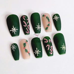 May include: Set of ten green, nude, and white Christmas-themed press-on nails with snowflake, candy cane, and holly designs.