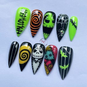 May include: A set of ten long, pointed artificial nails with Halloween-themed designs. The designs include a neon green nail with the word "HALLOWEEN", spirals, Jack Skellington, and bats. Colours include black, orange, yellow, and green.