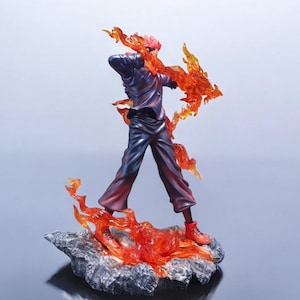 Detailed anime figure statue depicting a powerful cursed king and heroic fighter locked in battle, collectible display model for fans.