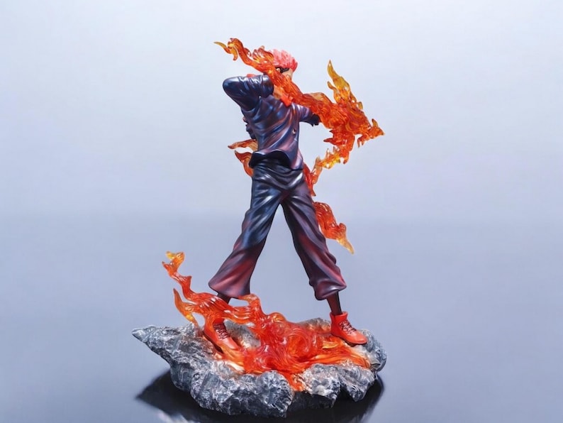 Detailed anime figure statue depicting a powerful cursed king and heroic fighter locked in battle, collectible display model for fans.
