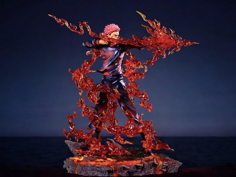 Detailed anime figure statue depicting a powerful cursed king and heroic fighter locked in battle, collectible display model for fans.