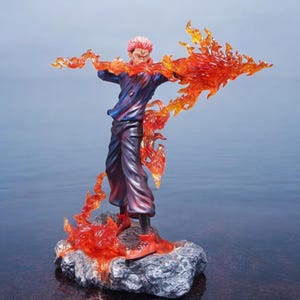 Detailed anime figure statue depicting a powerful cursed king and heroic fighter locked in battle, collectible display model for fans.