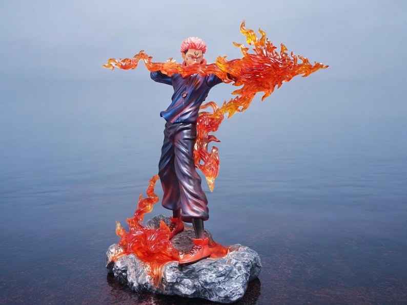 Detailed anime figure statue depicting a powerful cursed king and heroic fighter locked in battle, collectible display model for fans.