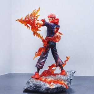 Detailed anime figure statue depicting a powerful cursed king and heroic fighter locked in battle, collectible display model for fans.