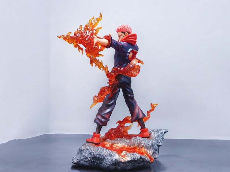 Detailed anime figure statue depicting a powerful cursed king and heroic fighter locked in battle, collectible display model for fans.