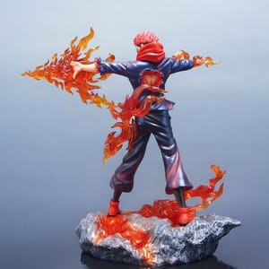 Detailed anime figure statue depicting a powerful cursed king and heroic fighter locked in battle, collectible display model for fans.