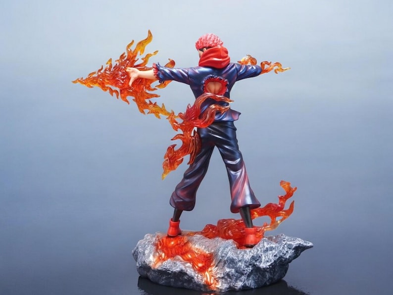 Detailed anime figure statue depicting a powerful cursed king and heroic fighter locked in battle, collectible display model for fans.