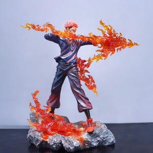 Detailed anime figure statue depicting a powerful cursed king and heroic fighter locked in battle, collectible display model for fans.