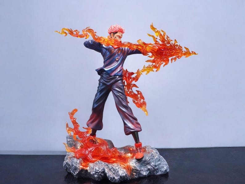 Detailed anime figure statue depicting a powerful cursed king and heroic fighter locked in battle, collectible display model for fans.