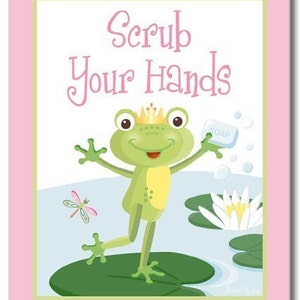 May include: A green frog wearing a gold crown holds a bar of soap and says "Scrub Your Hands". The frog is standing on a lily pad in a pond with a dragonfly flying nearby.