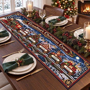 May include: A rectangular Christmas table runner featuring a festive train illustration on a dark blue background. The text "Grandma's Christmas Crew" is printed in gold. Train cars are labeled with the names David, Andy, Taylor, Timmy, and Julie.