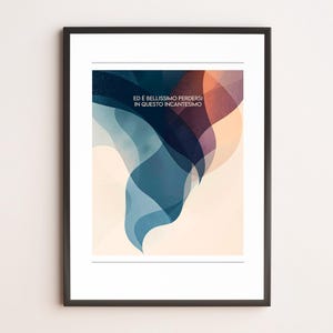 May include: Framed art print featuring abstract shapes in shades of blue, purple, and peach. The artwork includes the Italian text "ED È BELLISSIMO PERDERSI IN QUESTO INCANTESIMO" in a serif font, set against a light beige background.