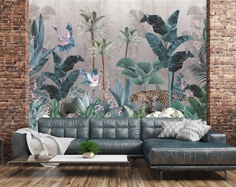 May include: A living room scene featuring a large, tufted, dark teal sectional sofa. A jungle-themed mural with palm trees, birds, and a leopard is on the wall. A brick wall and a small potted tree are on either side.