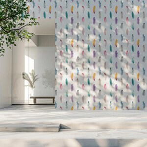 May include: A white wall with a repeating pattern of colourful watercolour feathers. The wall is in a room with a large window and a wooden bench.