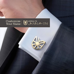May include: Gold cufflinks with a geometric design. The cufflinks feature a stylized logo with the text "JANNALYN" below it. The text "Customize Your Name" is also visible in the image.