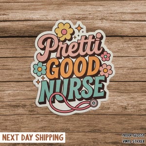 May include: A colorful sticker with the words "Pretti Good Nurse" in a retro font, surrounded by flowers and stars. A pink stethoscope graphic is included. The sticker is on a wooden background.